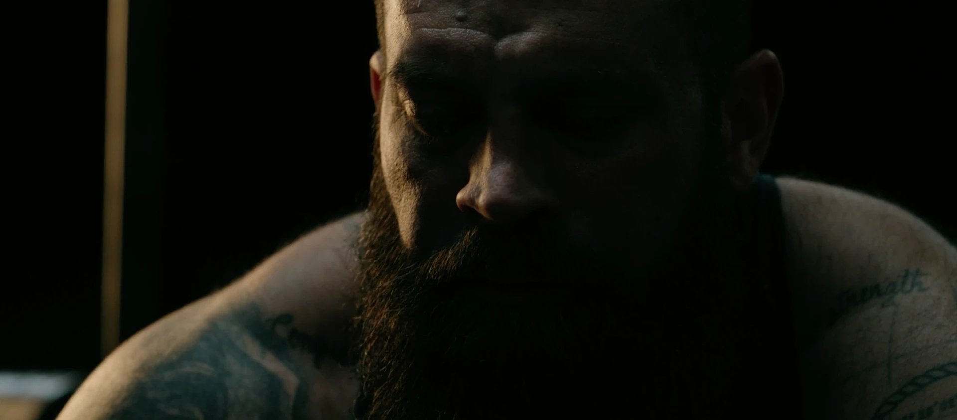 Jeff Marr in near darkness, head lowered